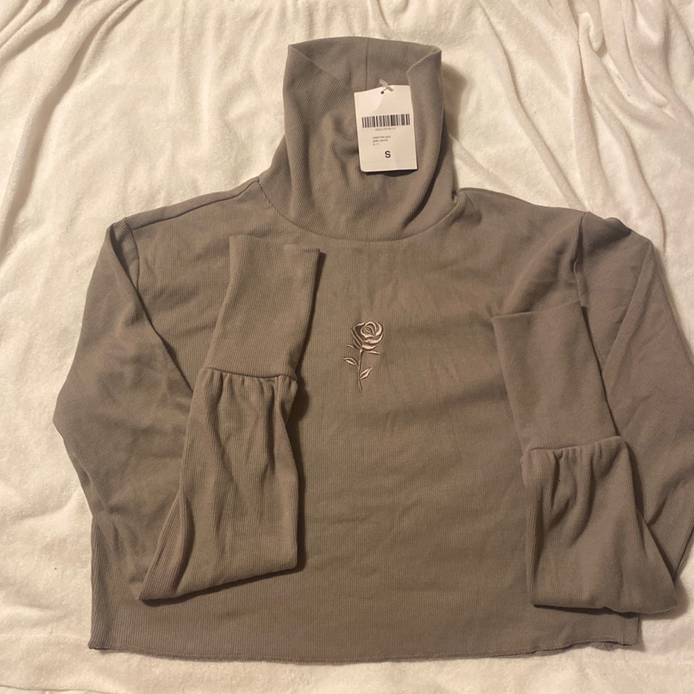 Embroidered rose turtle neck.